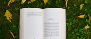 opened book on grass during daytime