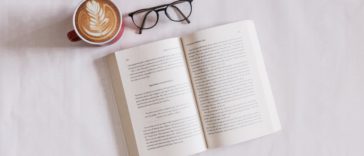 book near eyeglasses and cappuccino
