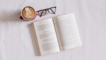 book near eyeglasses and cappuccino