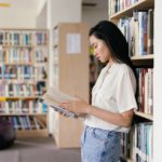 Photo by Mikhail Nilov: https://www.pexels.com/photo/female-student-reading-a-book-in-the-library-9158355/