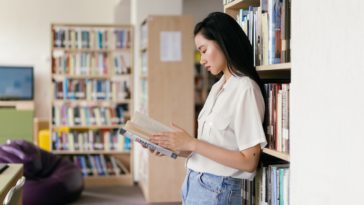 Photo by Mikhail Nilov: https://www.pexels.com/photo/female-student-reading-a-book-in-the-library-9158355/