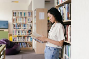 Photo by Mikhail Nilov: https://www.pexels.com/photo/female-student-reading-a-book-in-the-library-9158355/